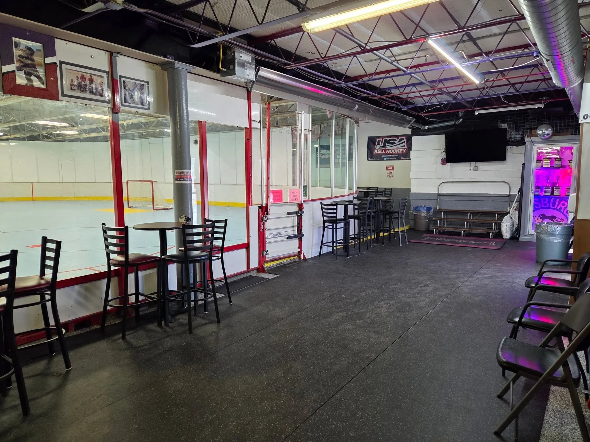 High-top tables in the Main Hall looking out over the glass onto the rink
